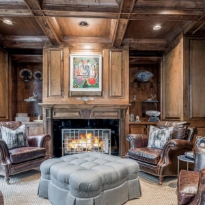 Lounge with real wood wall paneling and matching coffered ceiling. Wood beams with wood coffers, recessed lighting.