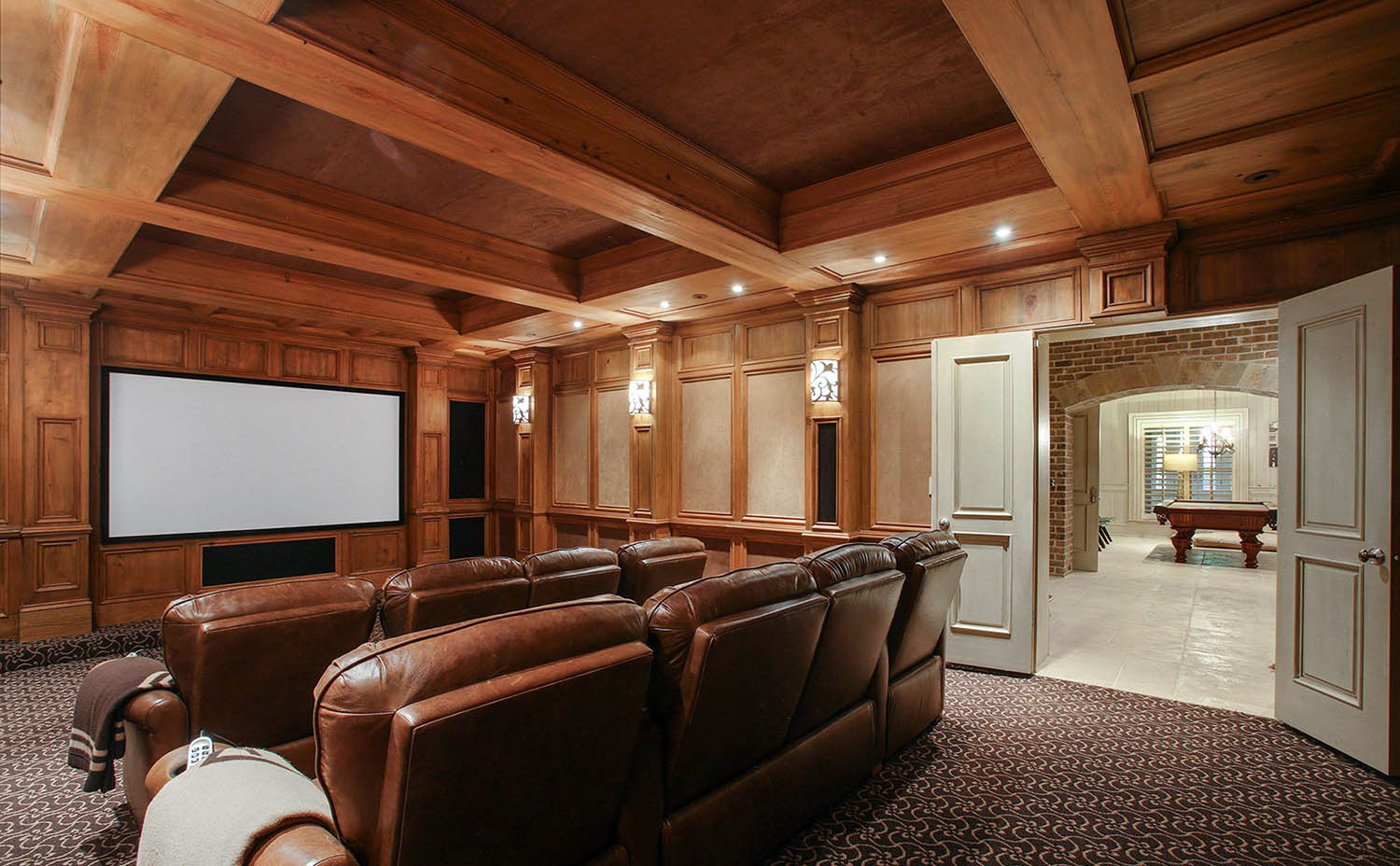 Wood theatre room with customwood coffered ceiling. Medium brown stain.
