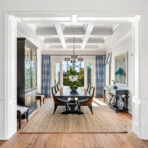 All white dining room design with coffered ceiling and soffits. Natural wide plank hardwood floors.
