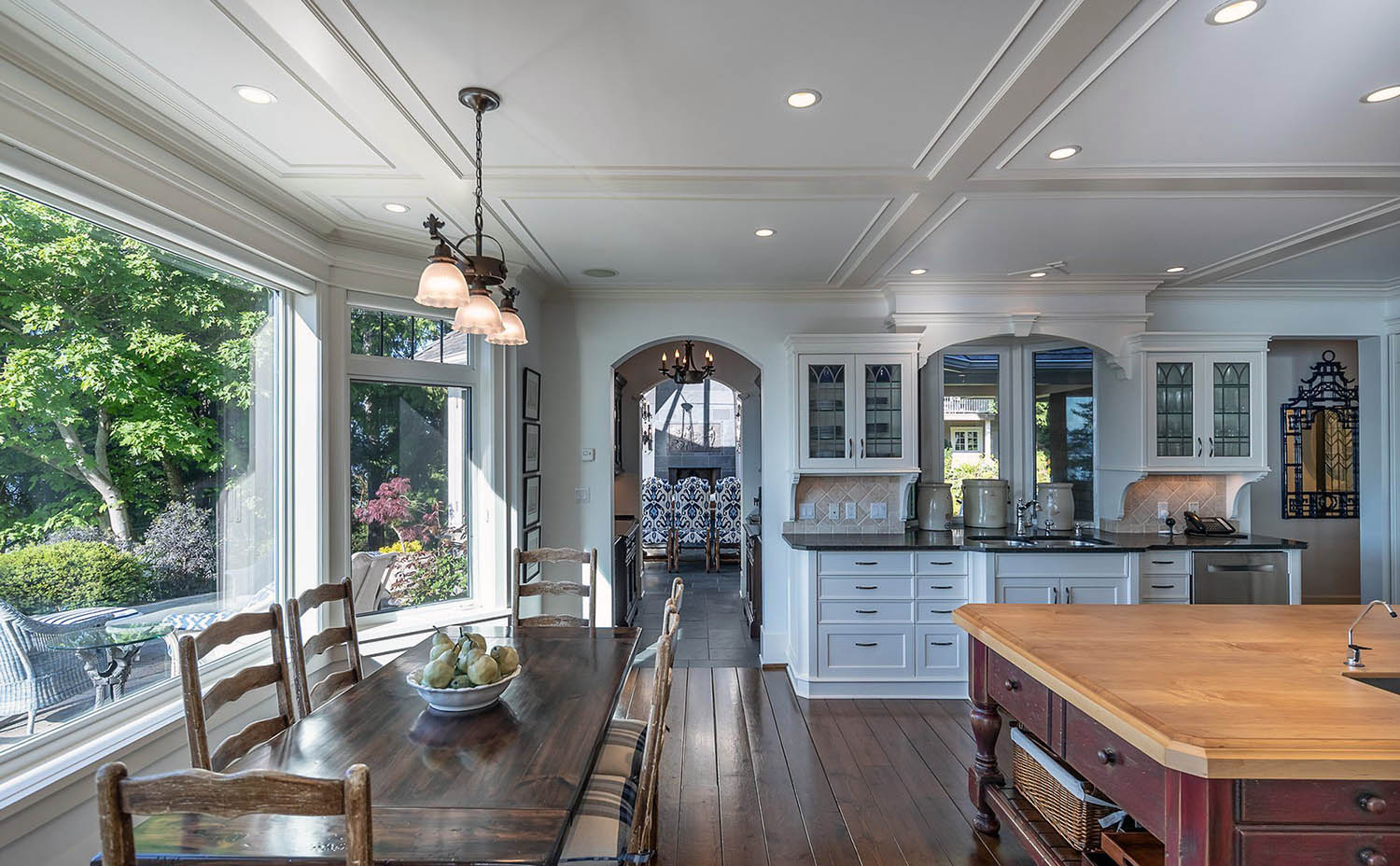 Low profile coffered ceiling in an open floor plan kitchen, dining and living room.