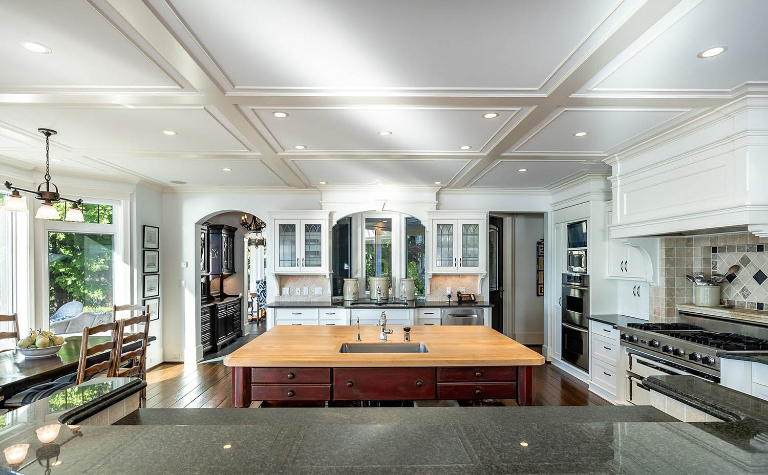 Low profile coffered ceiling in a custom kitchen. White beams and coffers with recessed lighting.