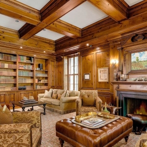 Study with wood walls and matching wood coffered ceiling. Wood beams with white coffers.