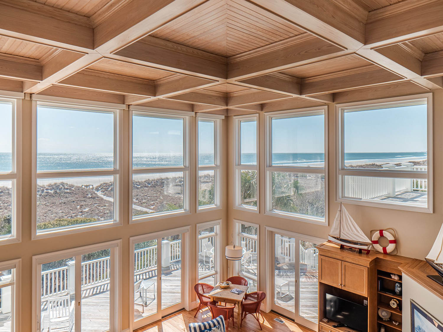 Ocean front beach house with cathedral ceilings, all tan wood with bead board coffers.