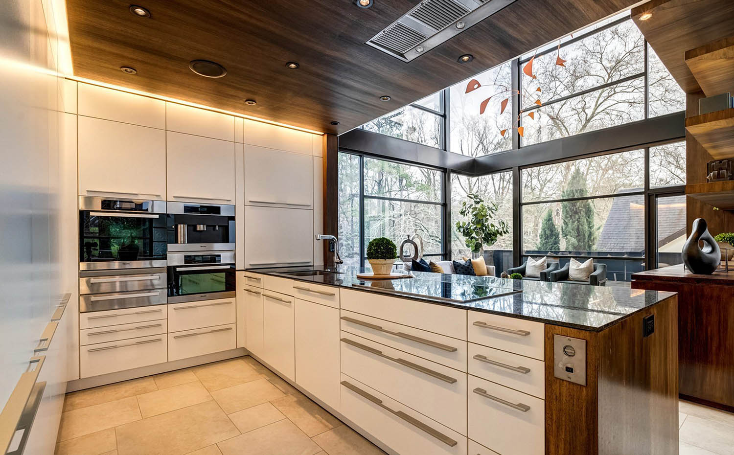Ultra modern kitchen with cream colored cabinets and real wood.