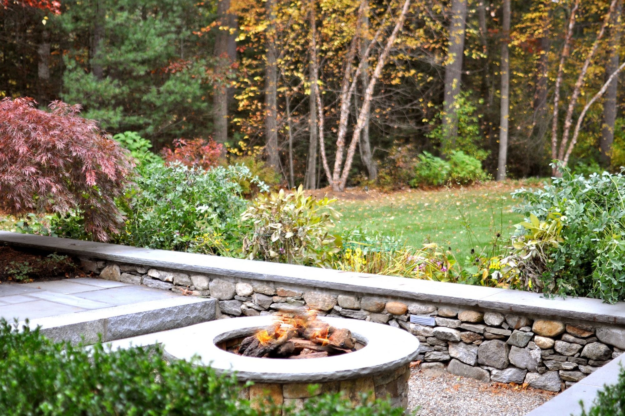 DIY patio seating stacked stone benches and a fire pit