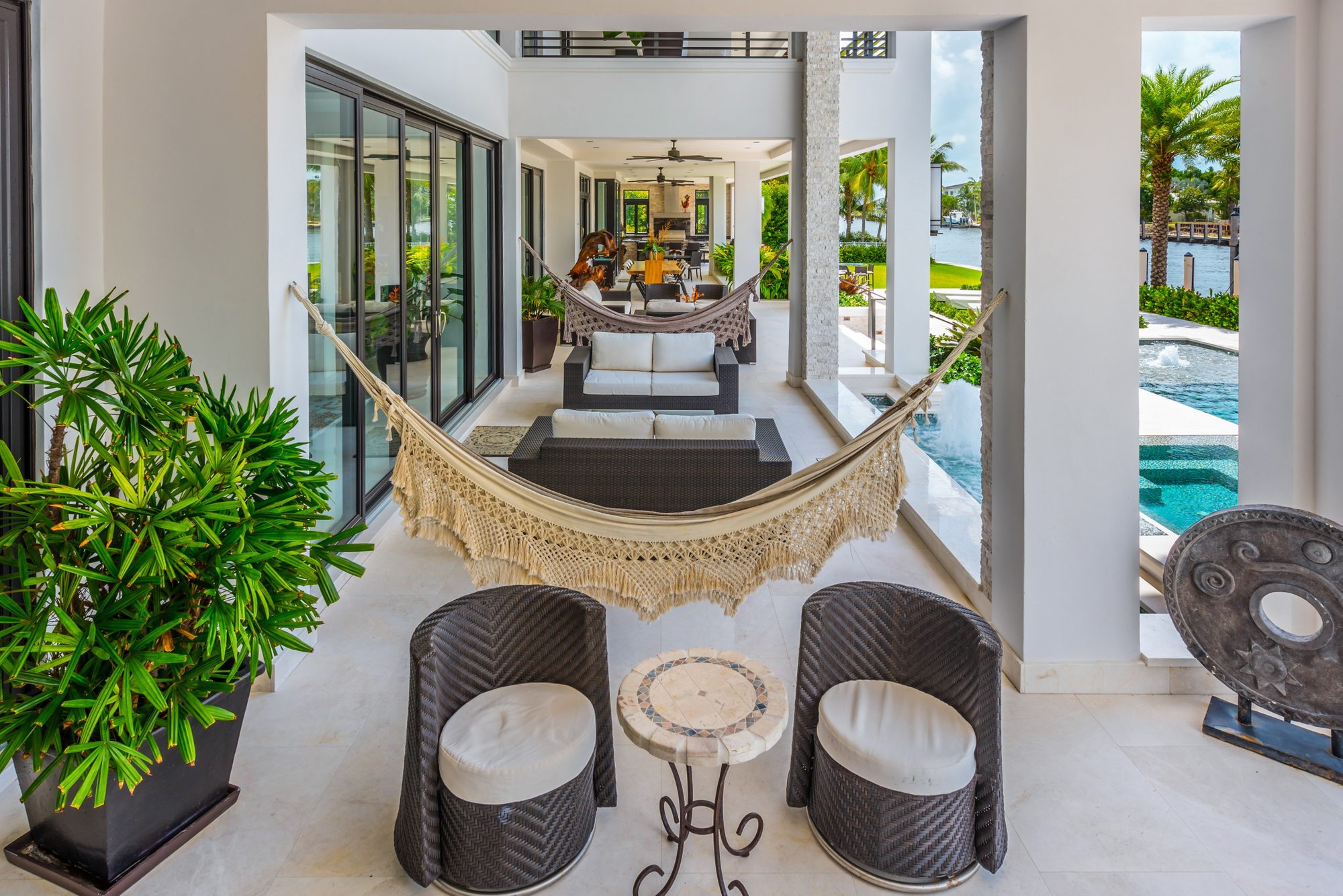 Bohemian inspired modern wicker patio furniture with hammocks.