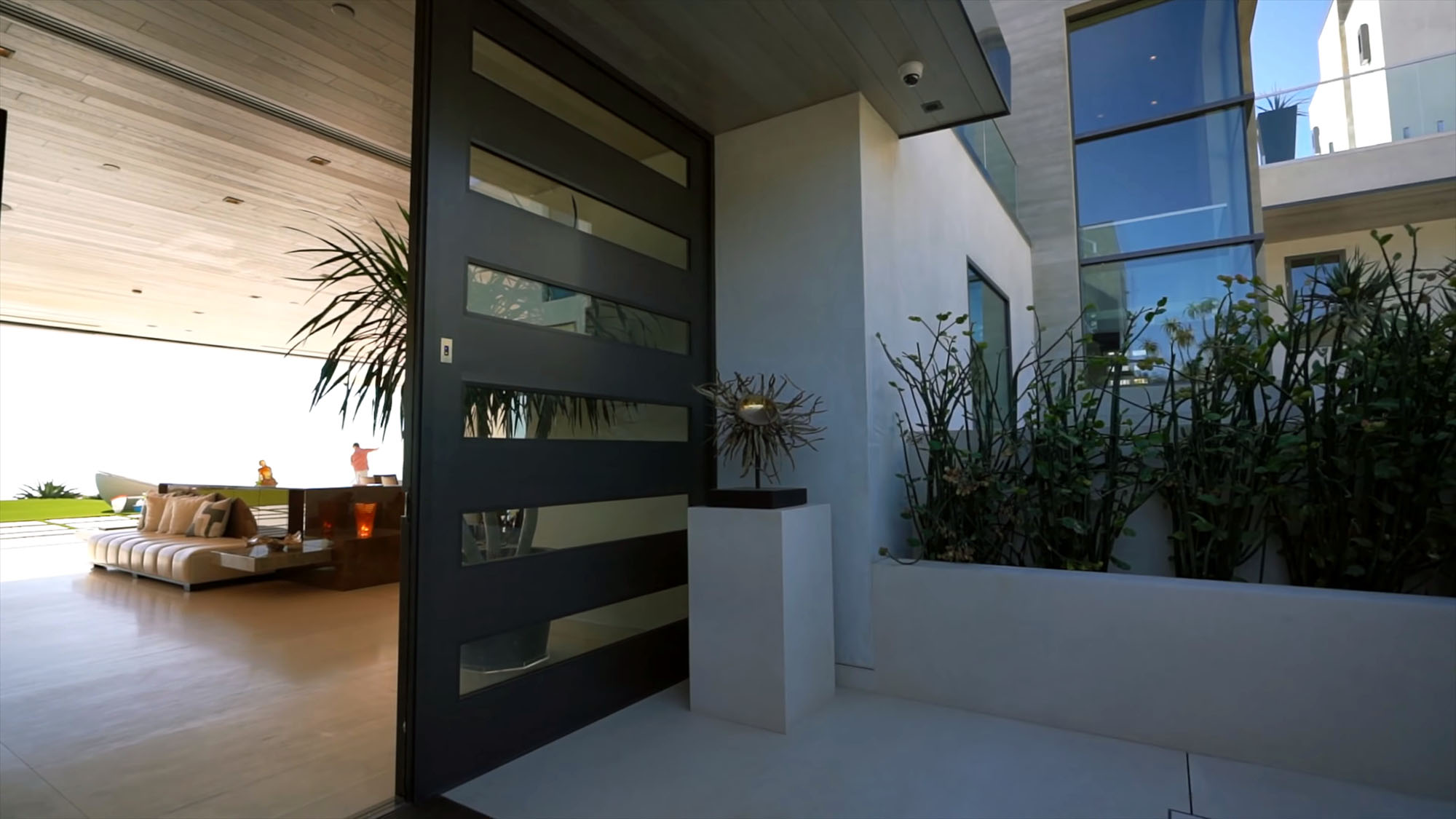 Huge french style modern black front door with horizontal glass panels.