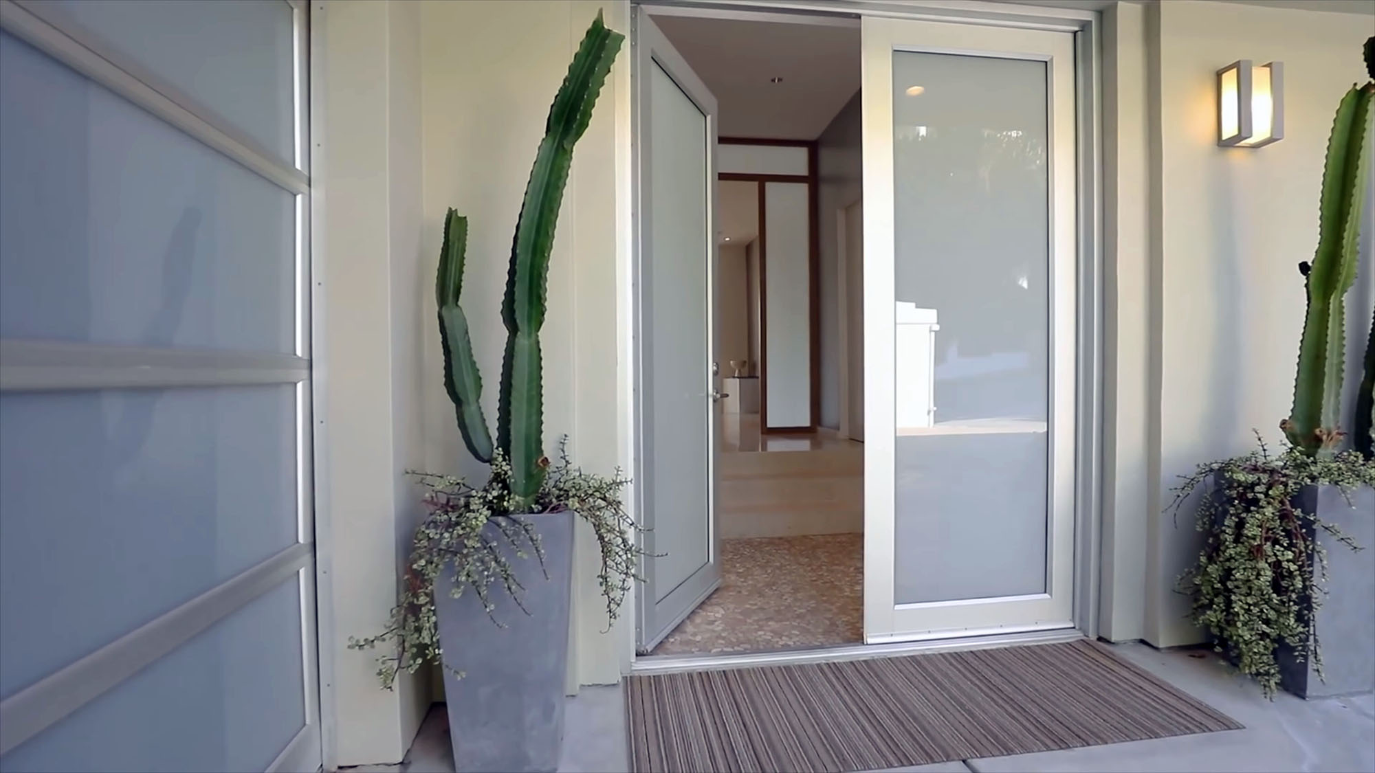 Modern all glass front door with frosted glass and a silver metal frame.
