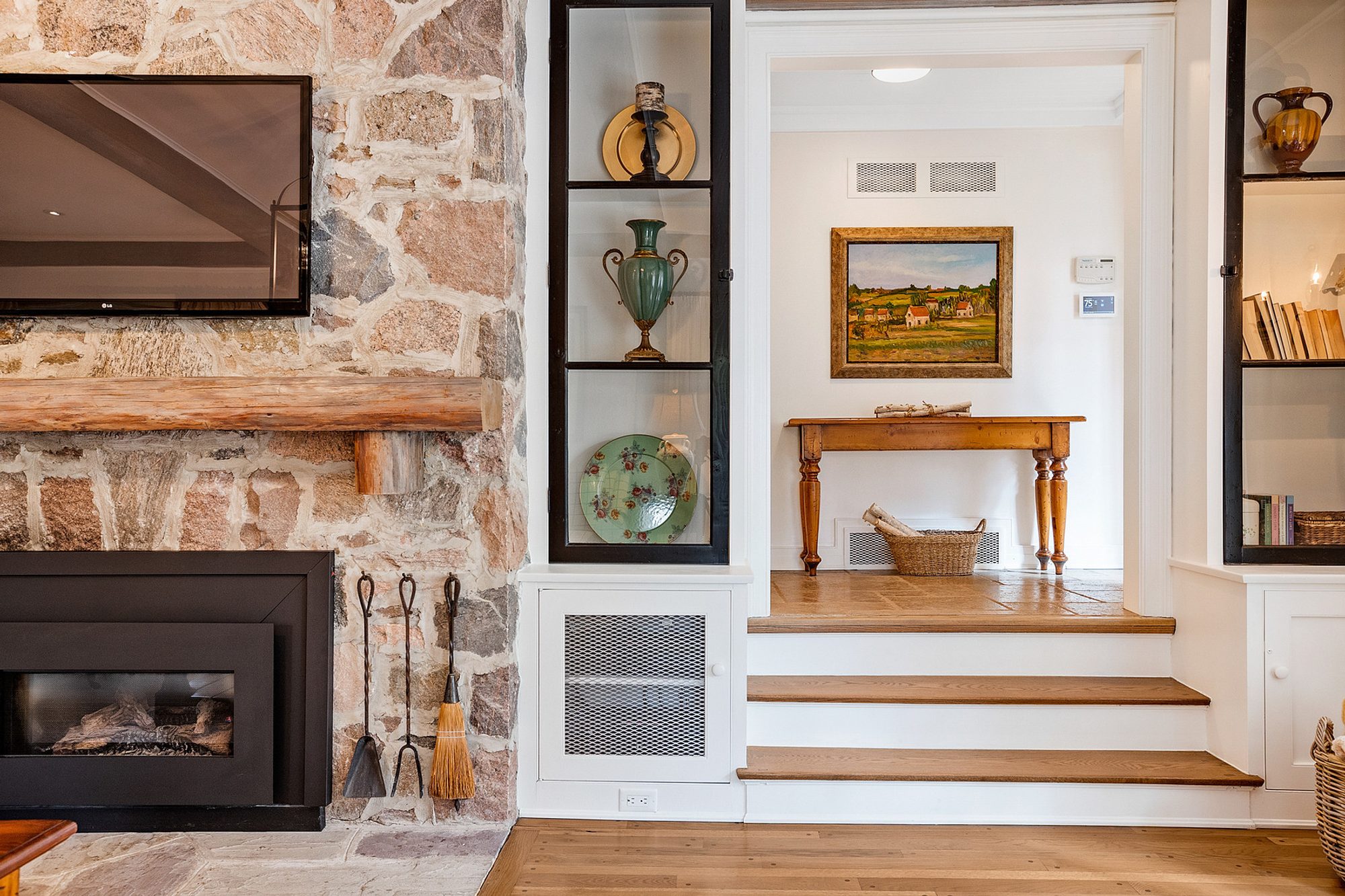 Rustic style real stone fireplace surround in a Transitional home with wide grout lines.