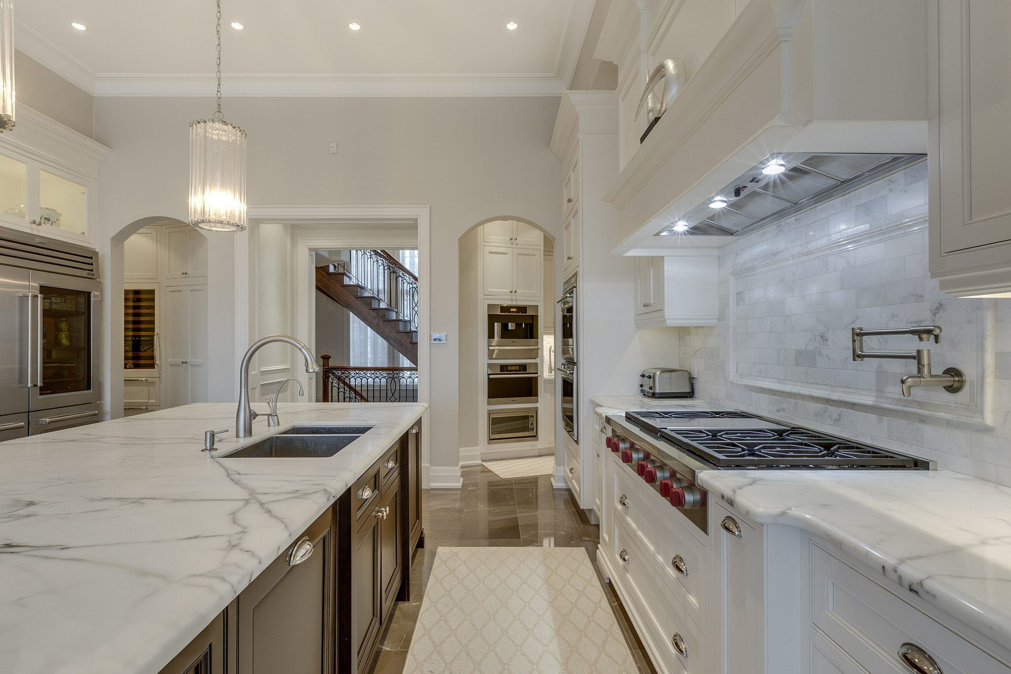 Marble kitchen counters with a deep gray vein.