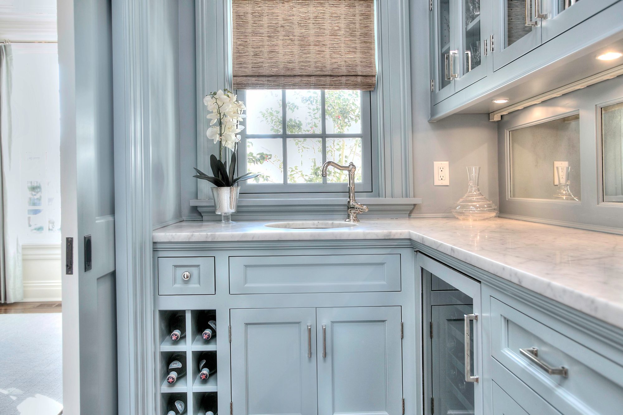 Light blue prep kitchen cabinets with marble counters.