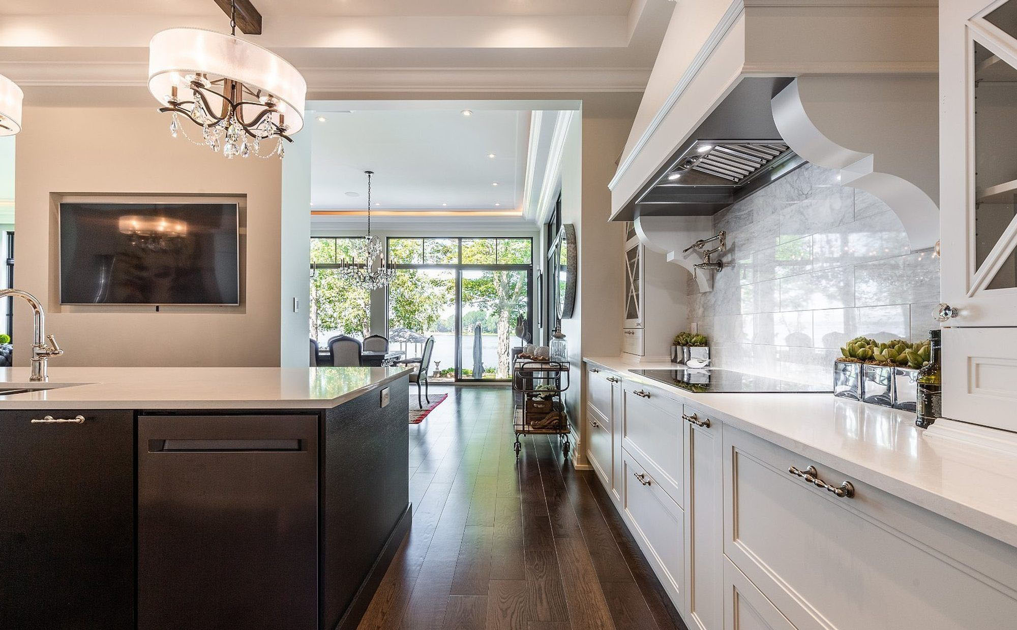 Beautiful luxury kitchen featuring a two toned cabinet design using white with a brown island.