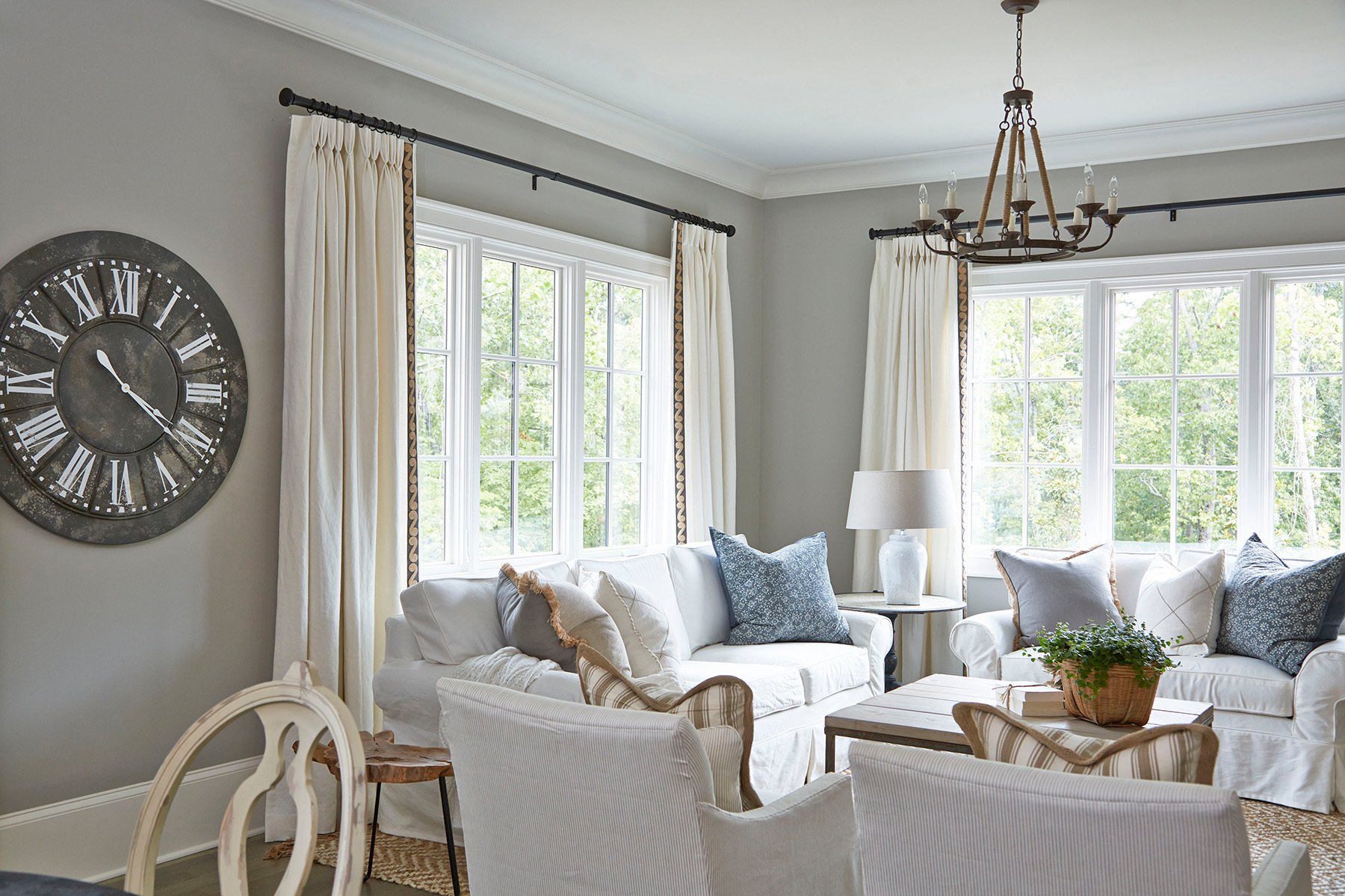 Traditional living room with white windows and trim. Gray walls.