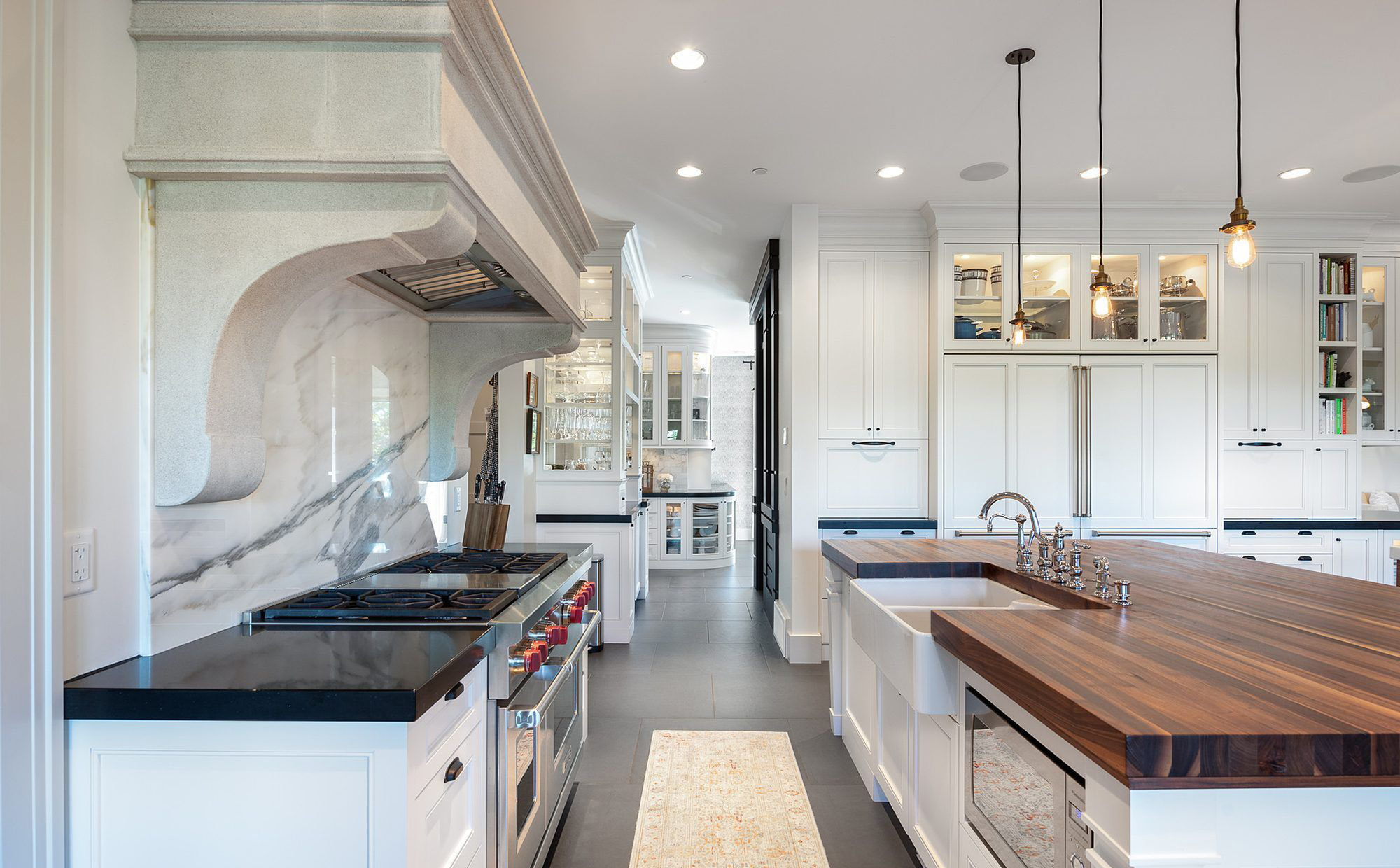 Beautiful kitchen with two different countertop colors, black and butcher block.