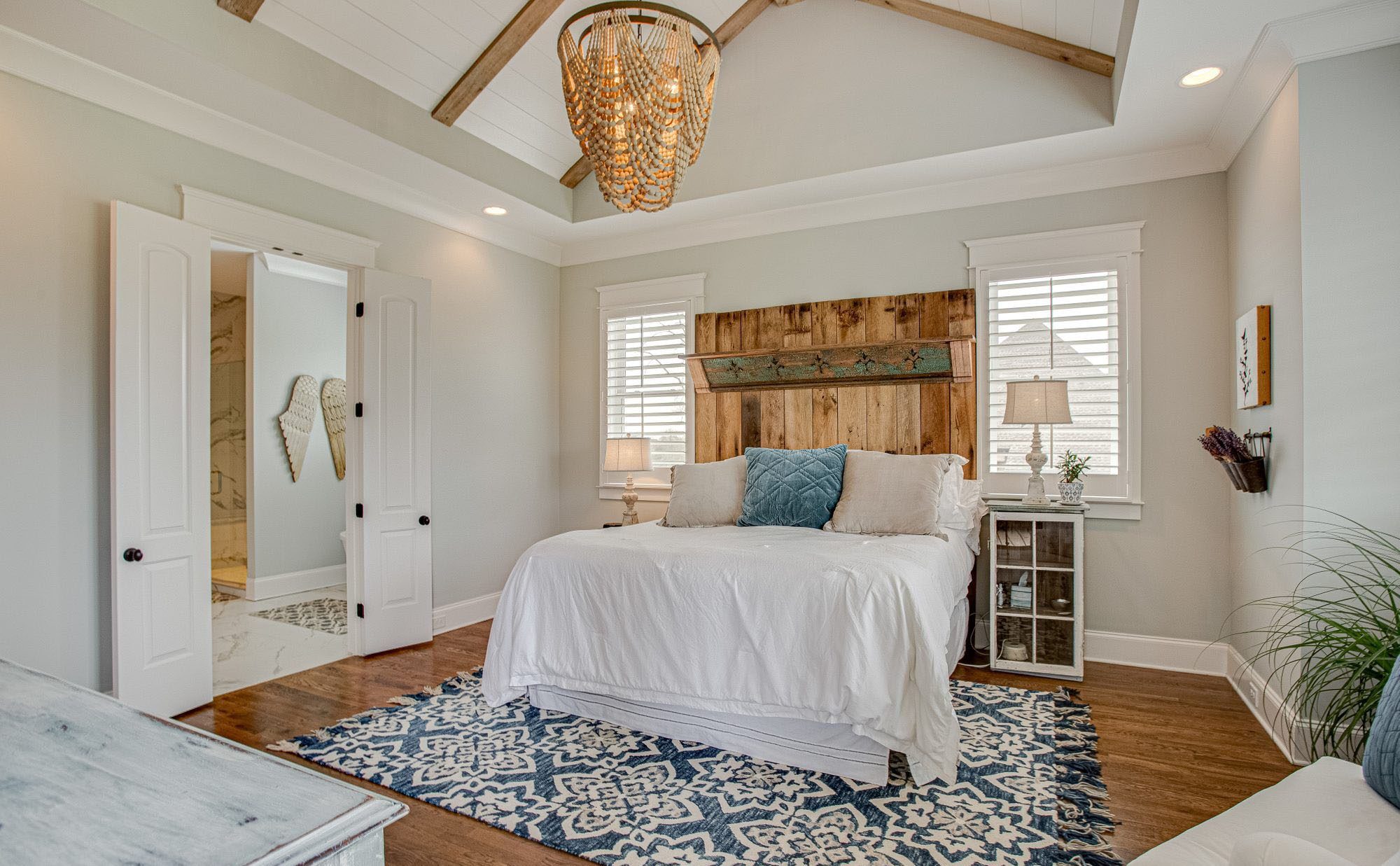Bedroom vaulted ceilings with exposed timber beams and shiplap.