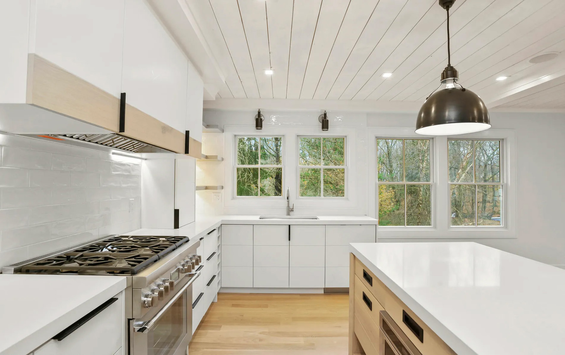 Tongue and groove kitchen ceiling painted white.