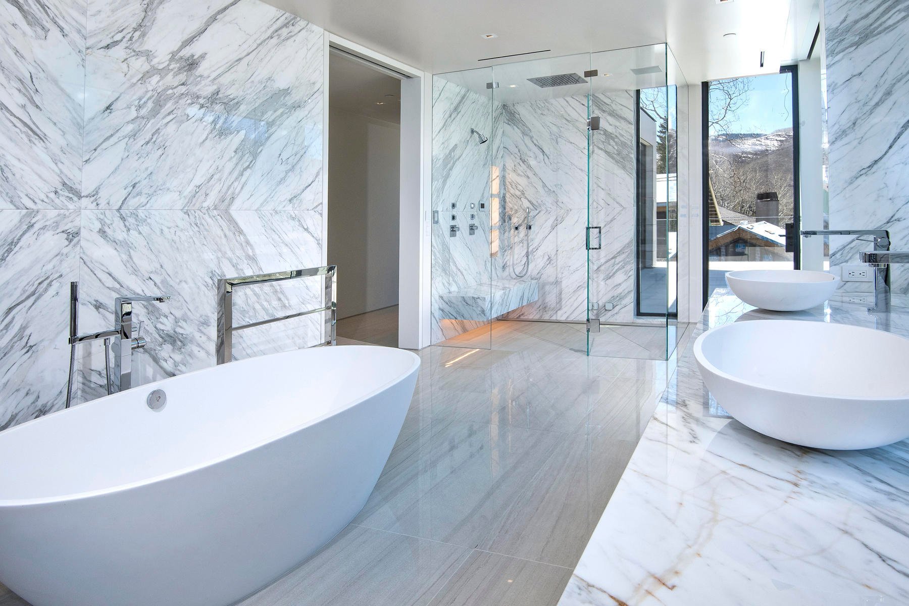 Roll-in shower with seamless porcelain tile floors.