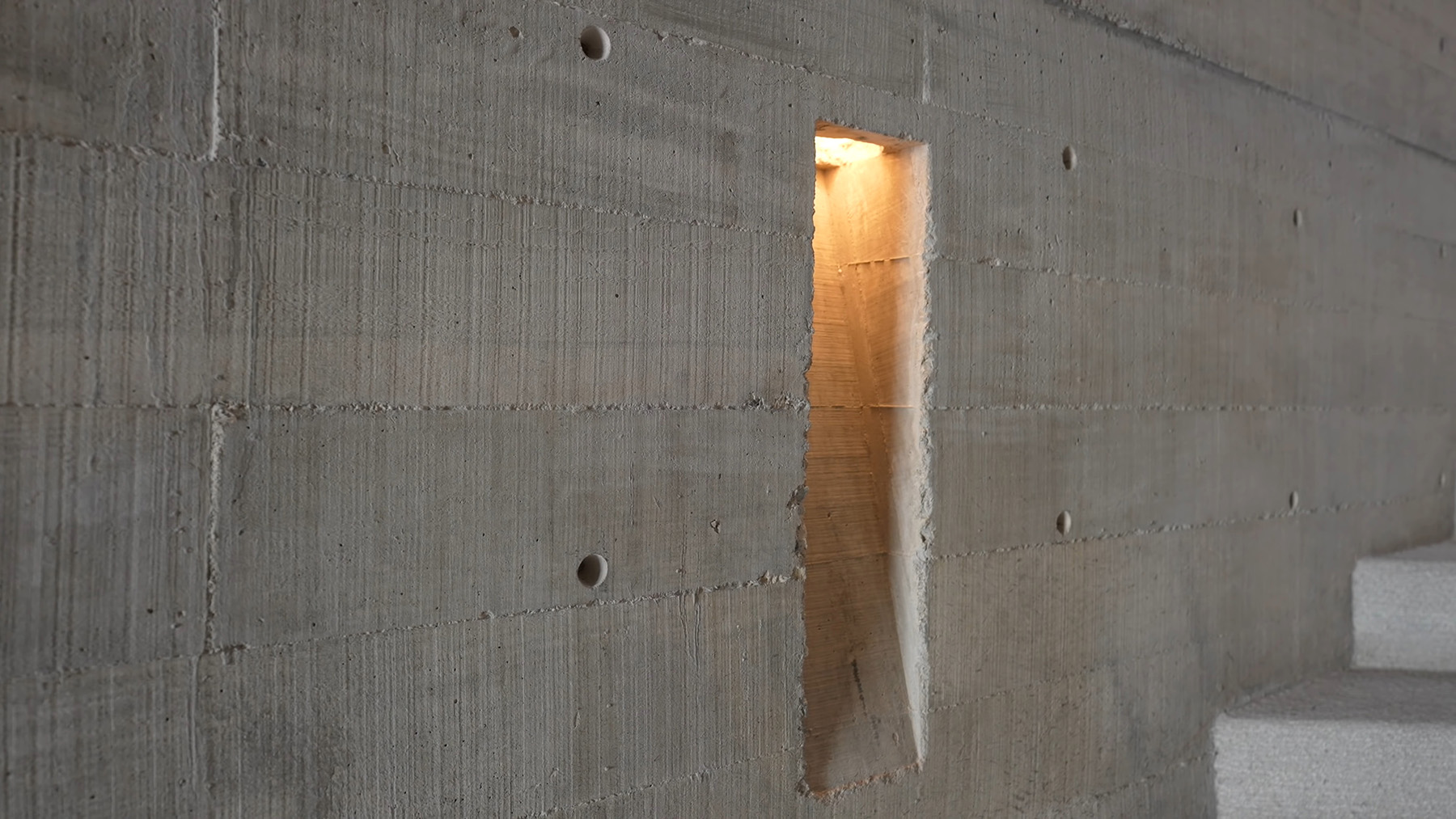 closeup view of board fromed concrete walls with built in lighting