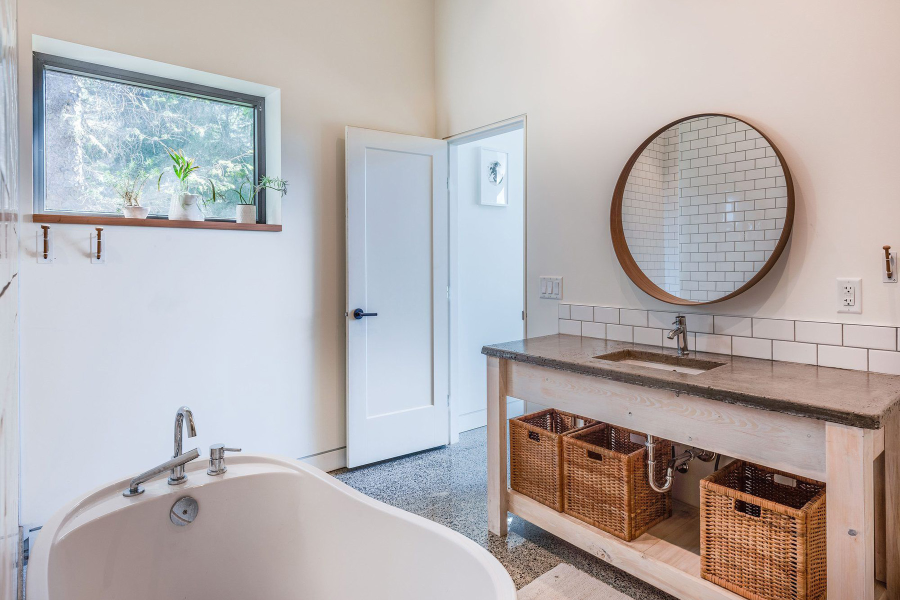 bathroom vanity with concrete countertop, white undermount sink, white tile backsplash