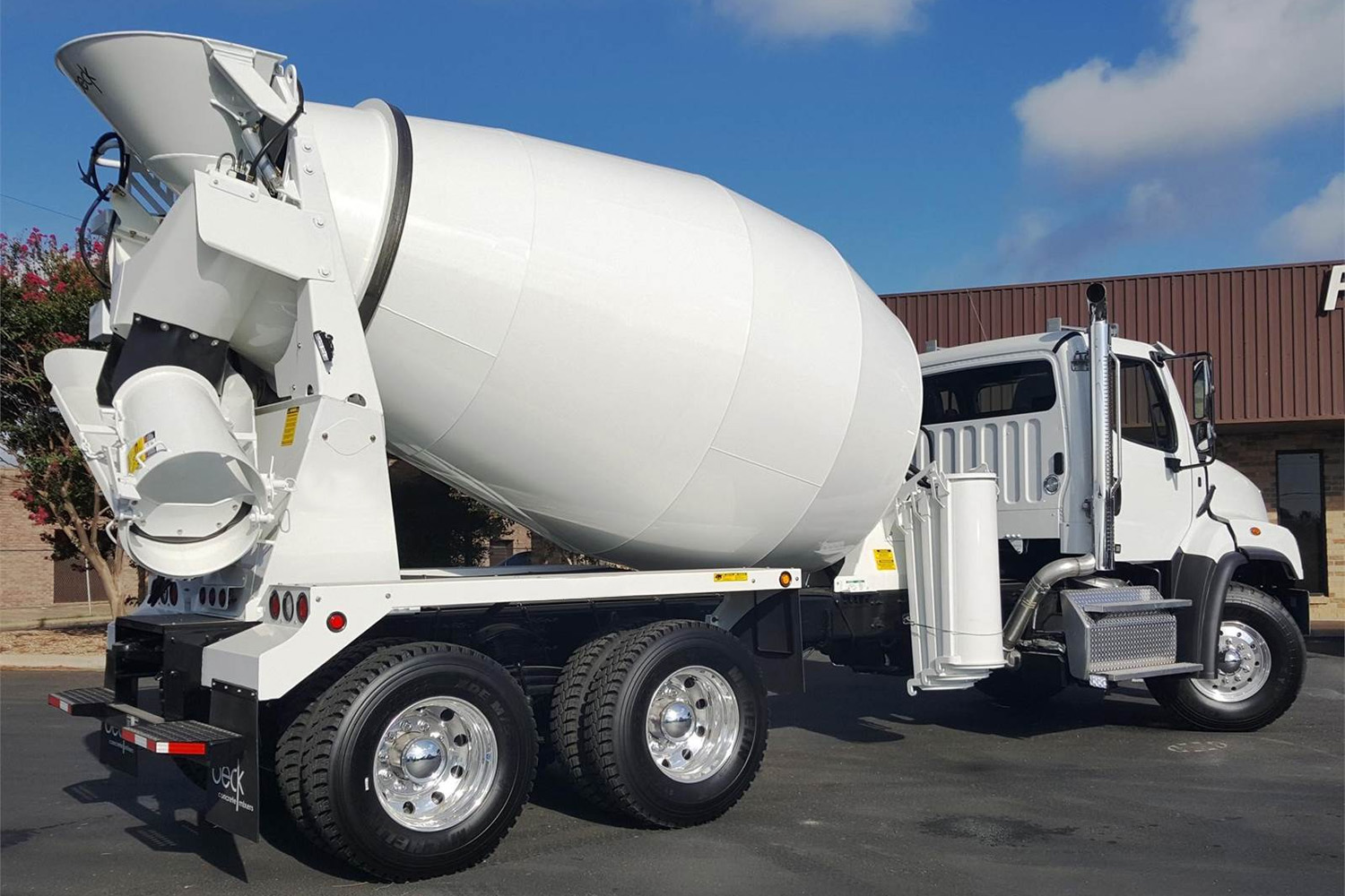 Rear side view of a new concrete truck.