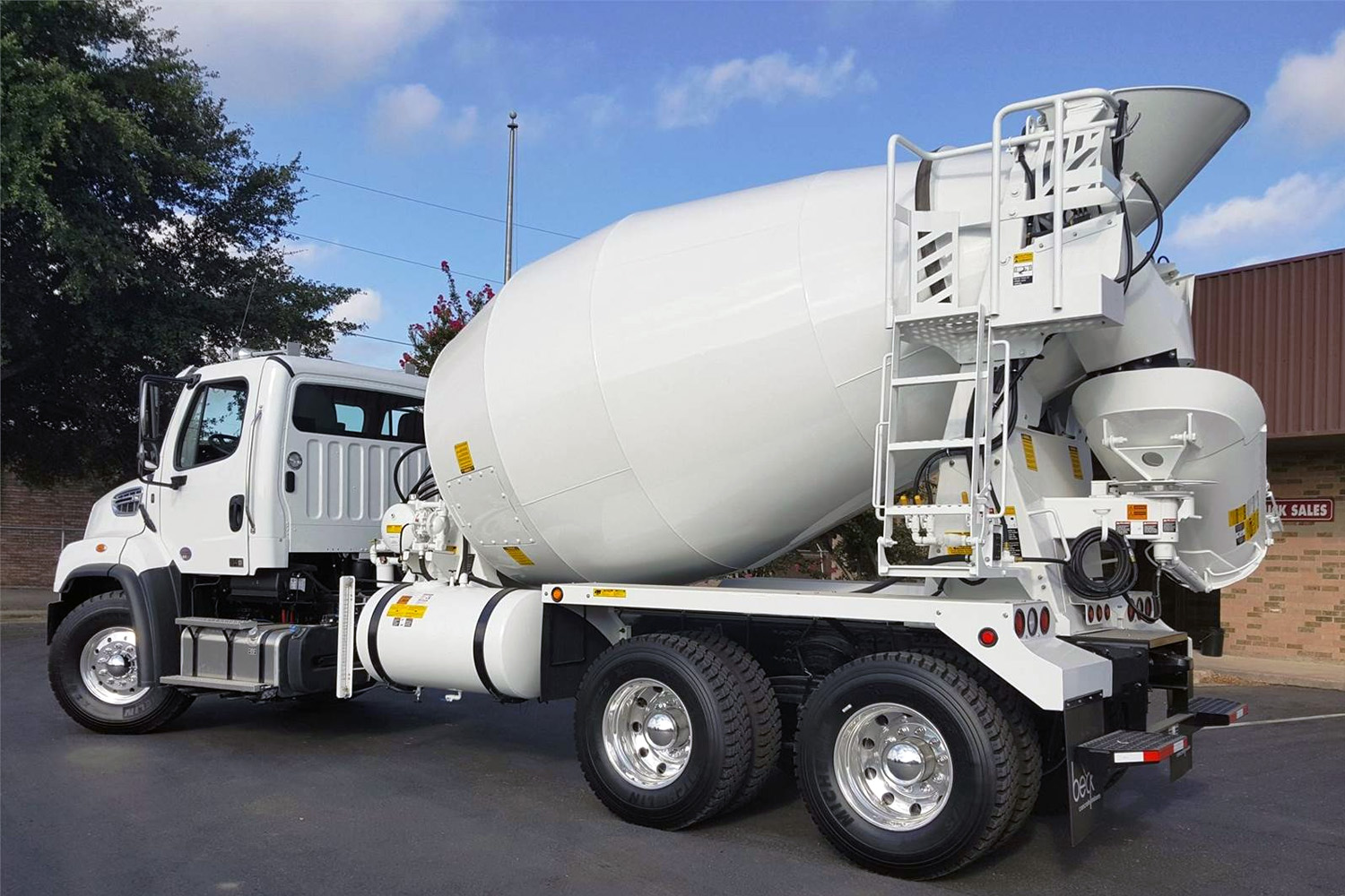 Rear left side view of a new concrete truck.