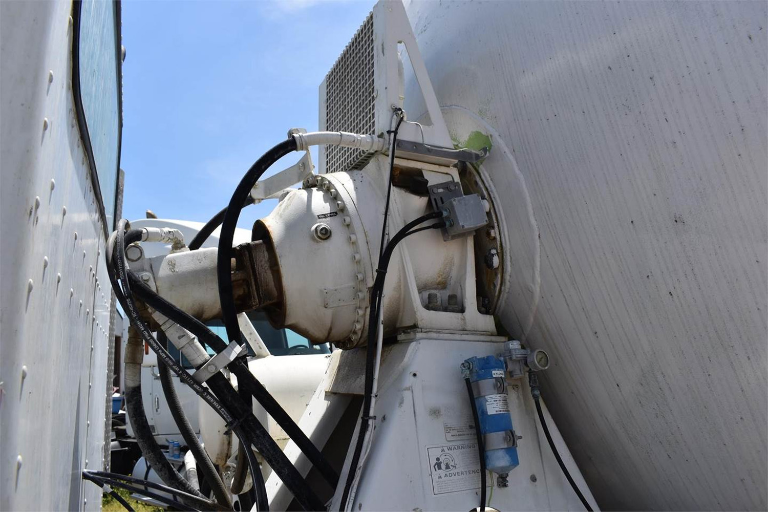 Closeup pic of the mechanical hydraulic system that turns the truck's concrete mixer.