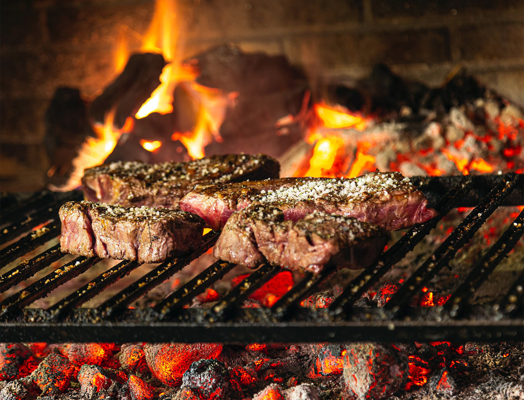 ribeye vs t-bone steak grilling over an open flame