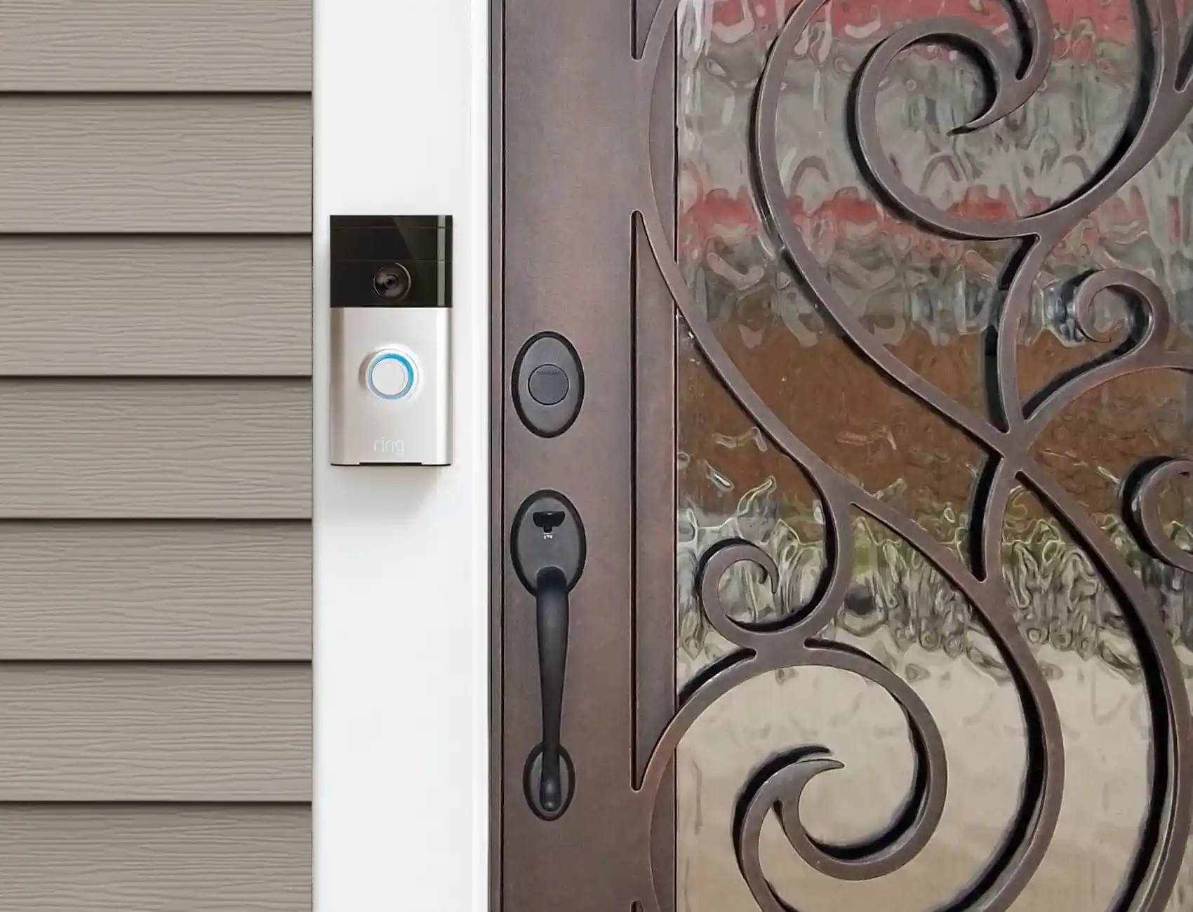 Ring Doorbell, iron & glass front door with swirls, tan siding 1.0