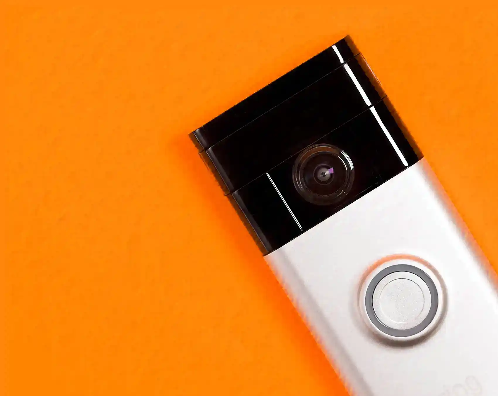 closeup of Ring doorbell on an orange background 1.0
