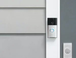 ring doorbell mounted next to a gray door 1.0
