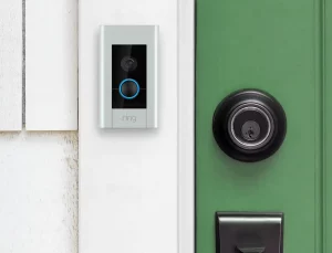 ring doorbell mounted next to green front door white siding 1.0