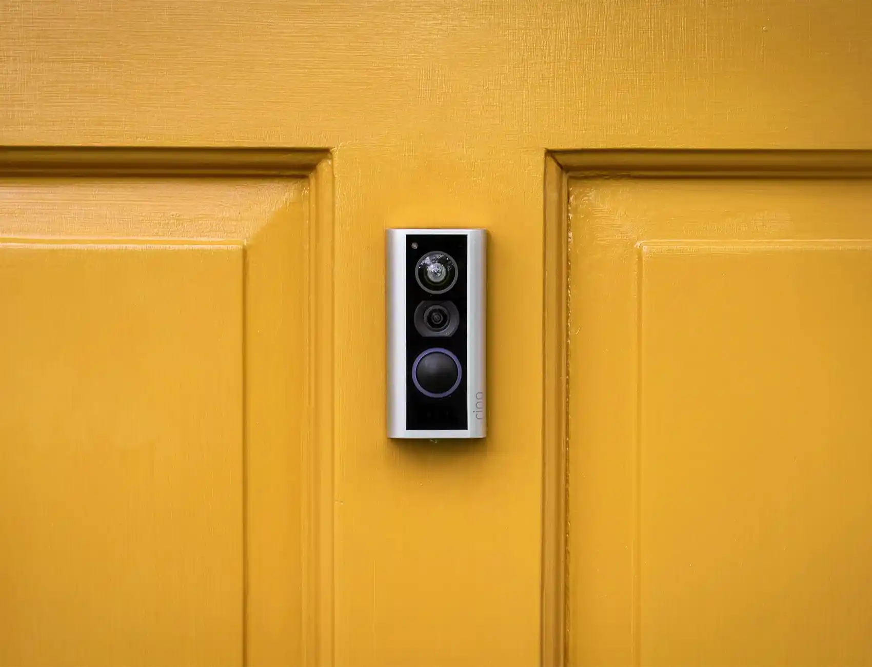 Ring peephole cam on a yellow front door