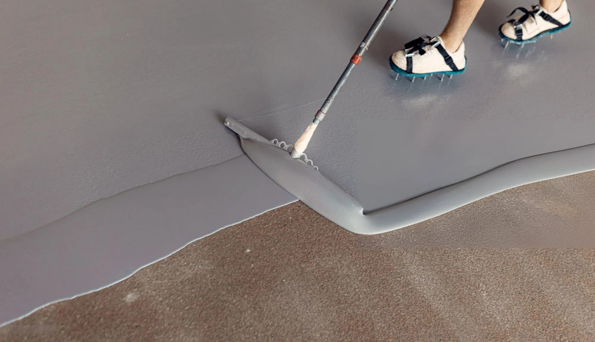 grey epoxy basement flooring NJ applied with a squeegee 