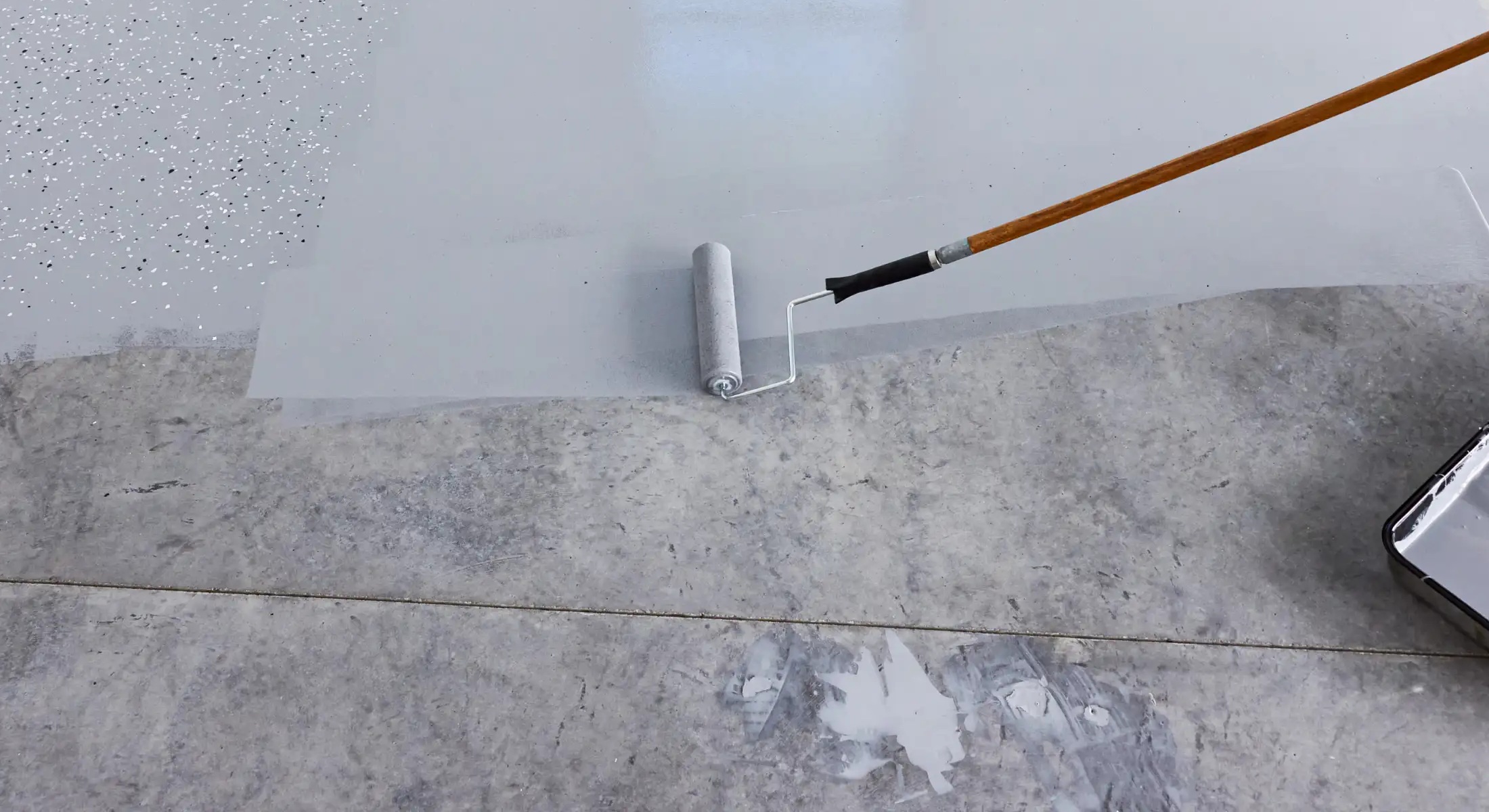 Grey epoxy concrete flooring NJ applied with a roller